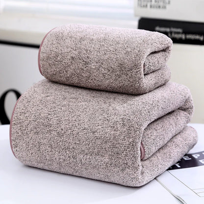 Two folded towels on a surface with a blurred background