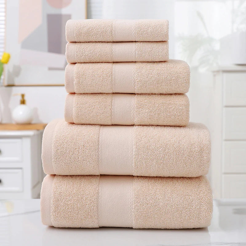 Stack of beige towels on a white surface with a blurred background