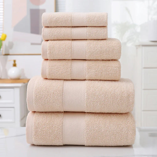 Stack of beige towels on a white surface with a blurred background