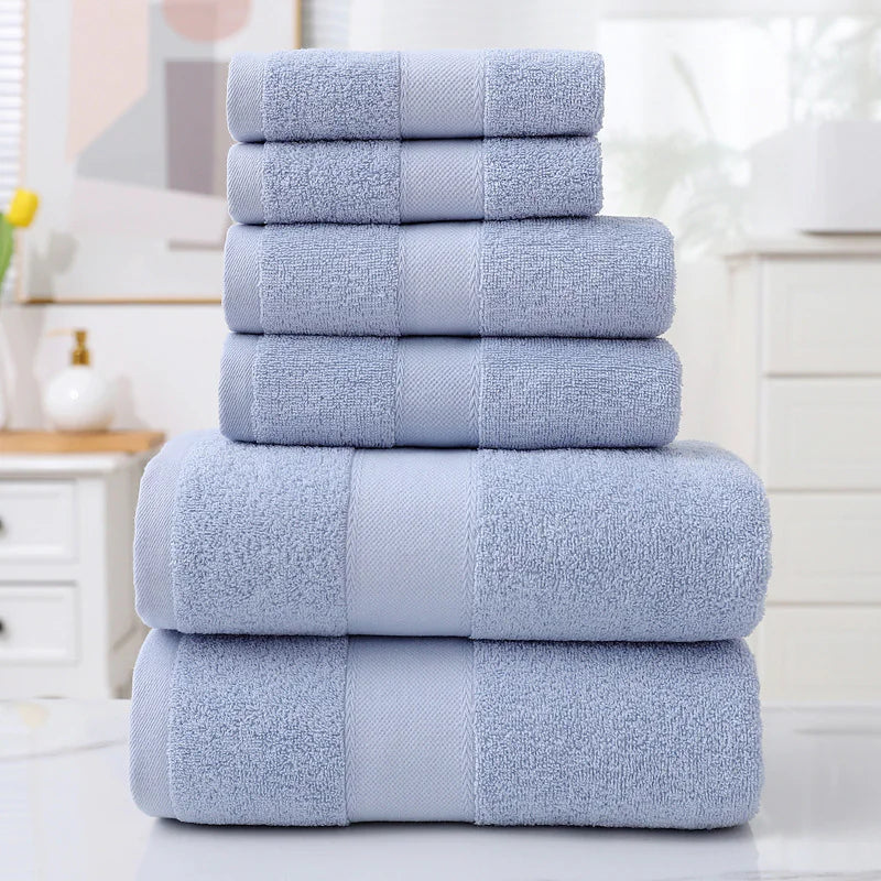 Stack of blue towels on a white surface with a blurred background