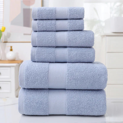 Stack of blue towels on a white surface with a blurred background