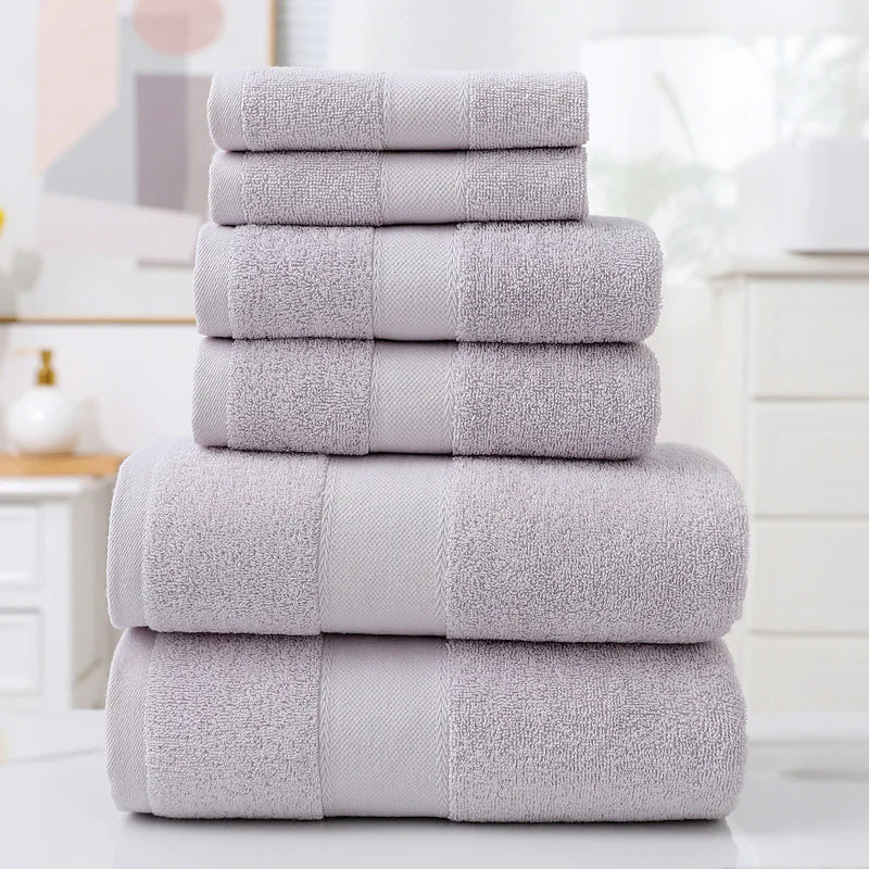 Stack of gray towels on a white surface with a blurred background