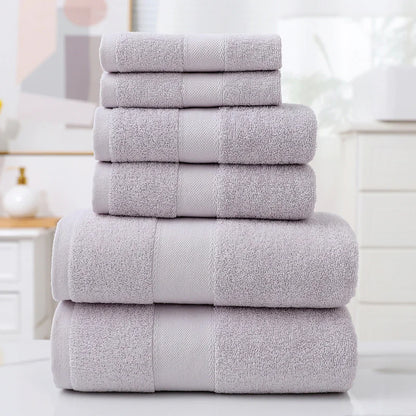 Stack of gray towels on a white surface with a blurred background